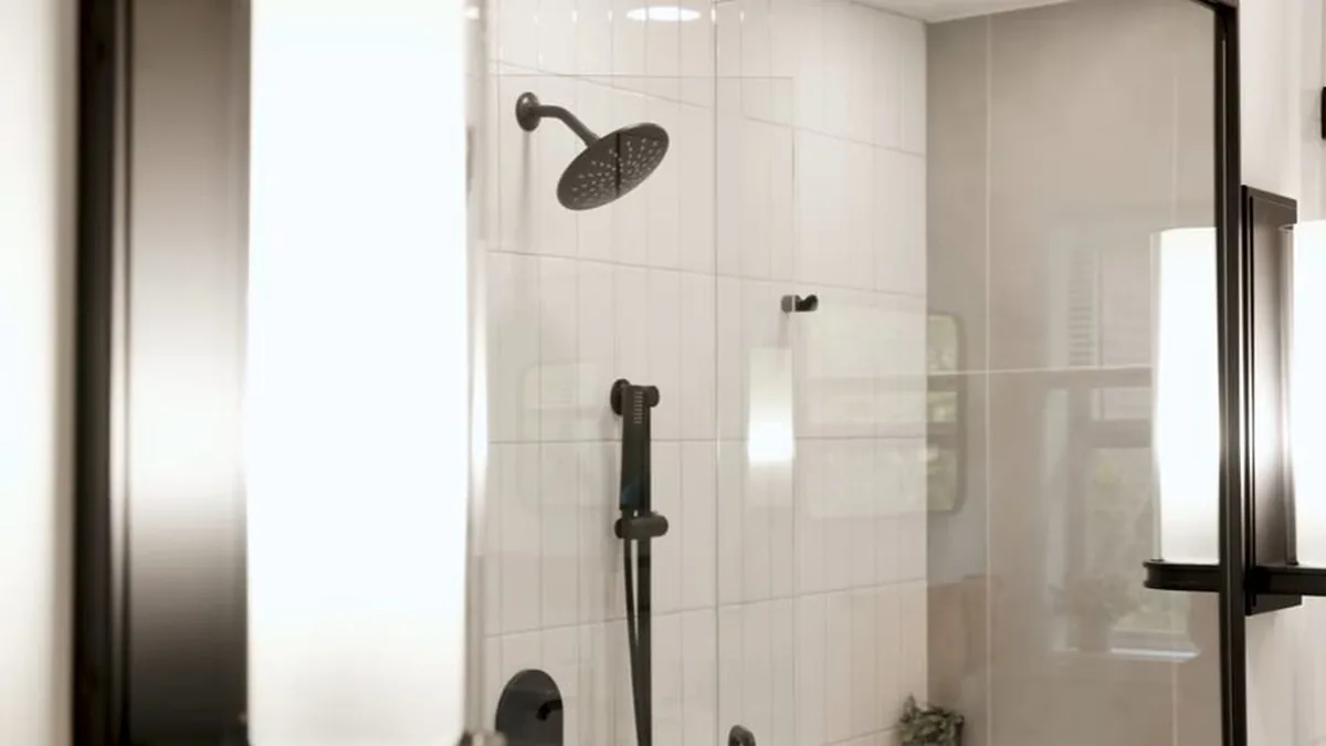 Plumber connecting drain plumbing during a Castle Crest bathtub installation
