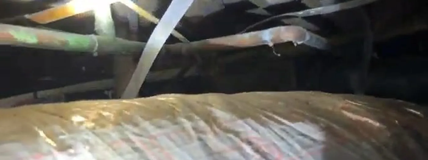 Close-up of a pipe section split open by freezing water inside