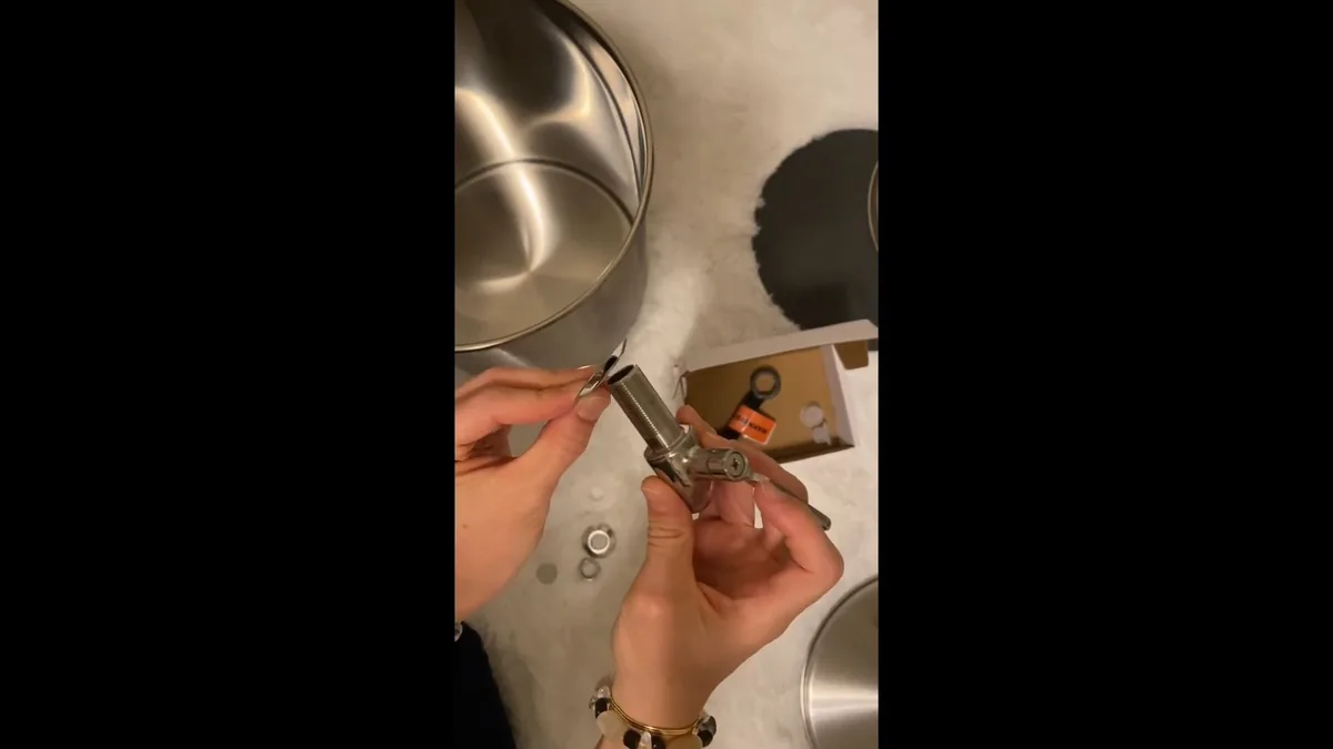 Plumber threading a gas line fitting for a new appliance connection