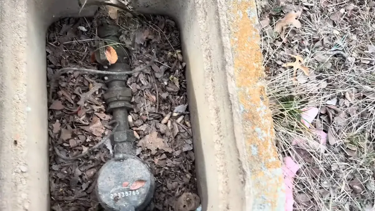 Plumber replacing an outdoor hose bib on an exterior wall