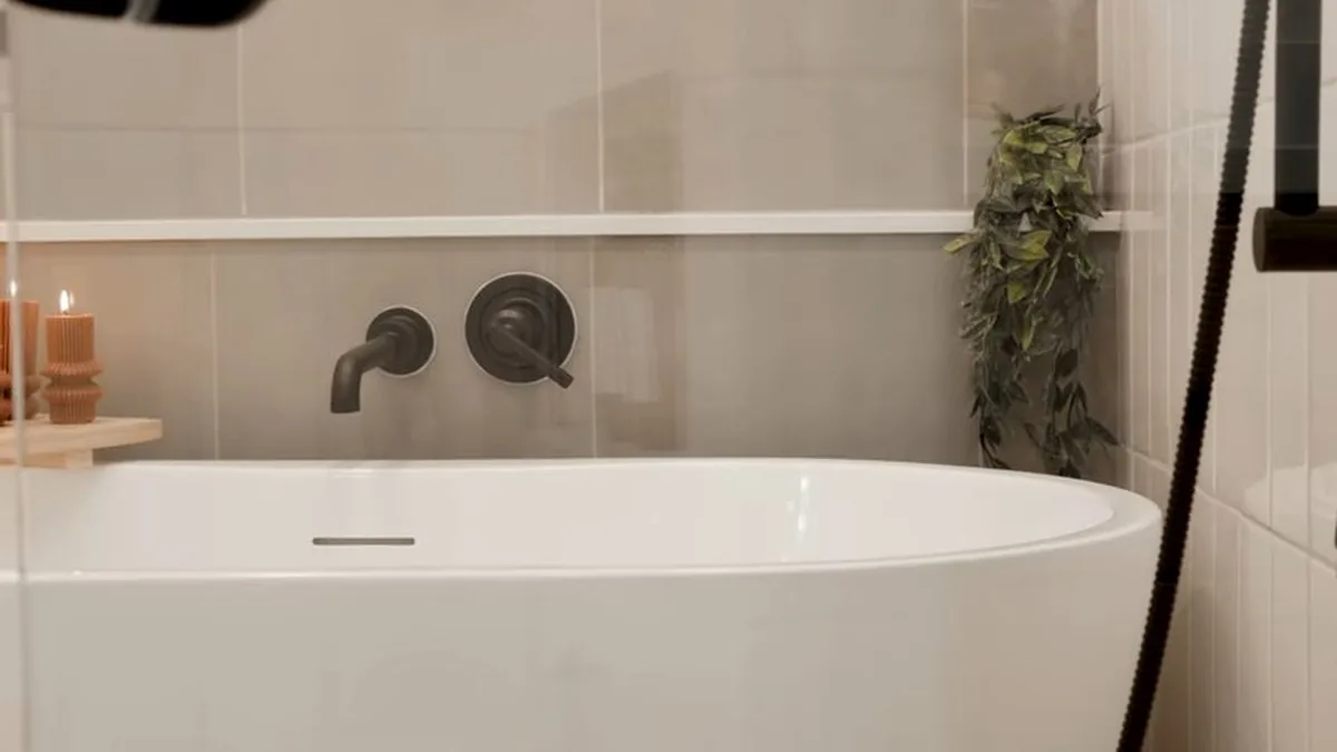 Plumber setting a shower valve during a Sun Canyon bathroom update