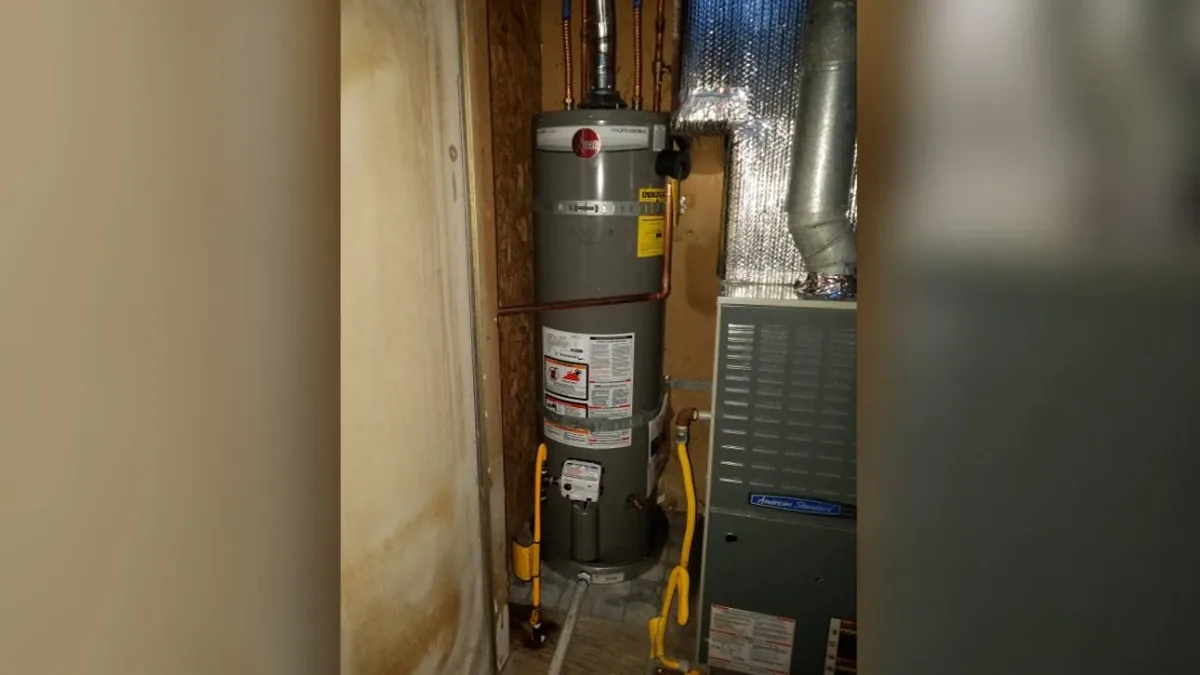 Plumber servicing the connections on a tankless water heater unit
