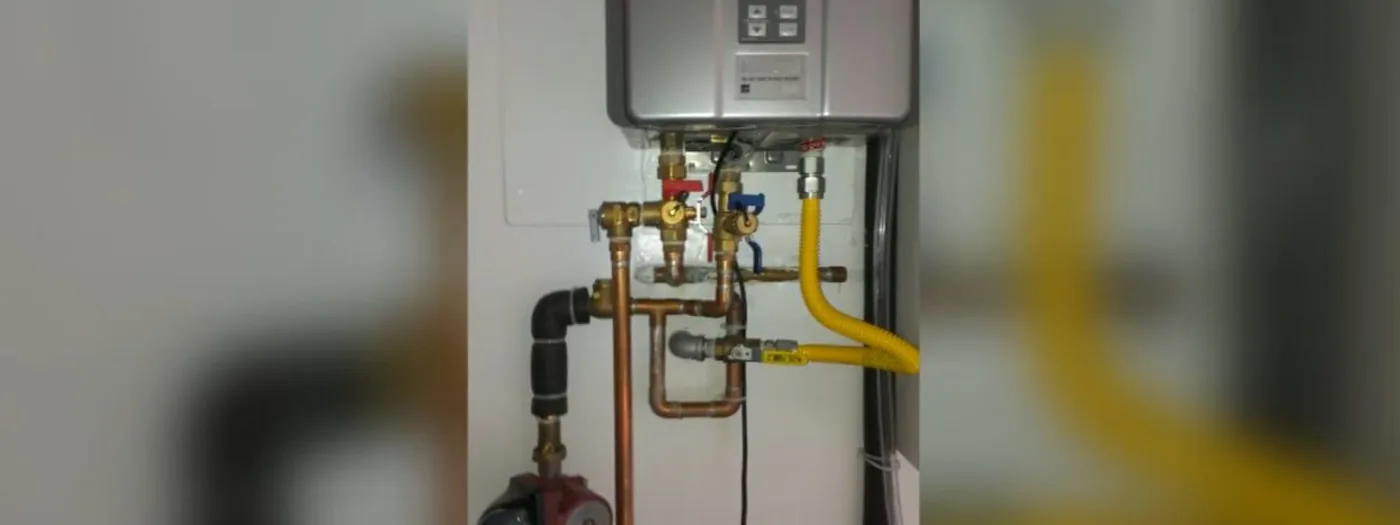 Water heater unit showing wear typical of years on hard, untreated water
